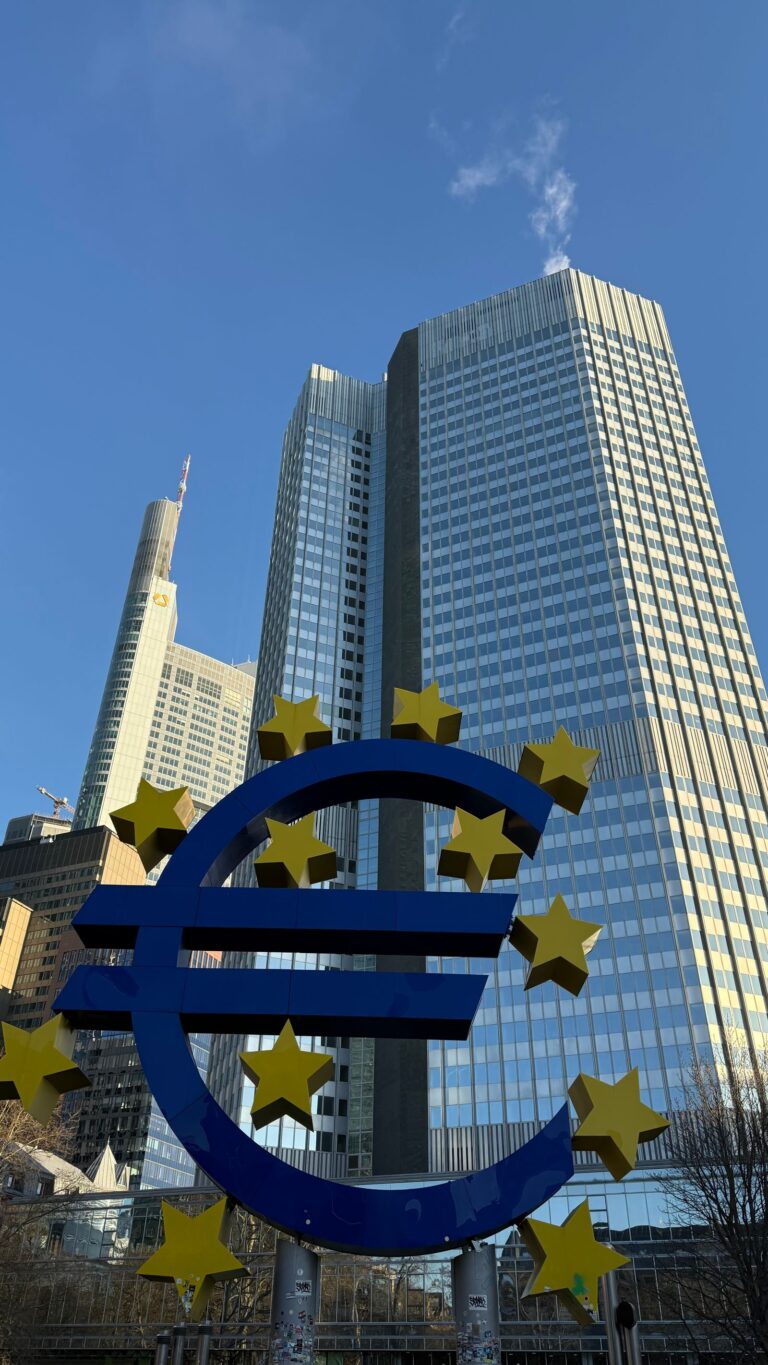 Euro sign sculpture with gold stars outside the European Central Bank tower in Frankfurt