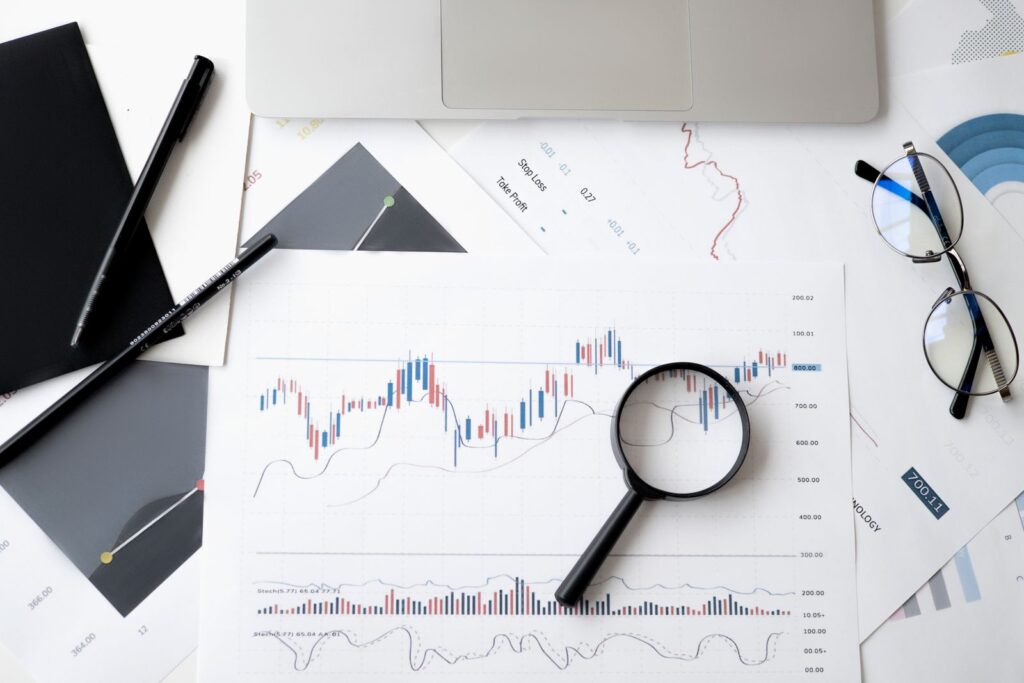 Magnifying glass over stock market charts - unconventional investing analysis
